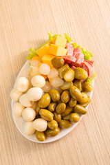 dish with quail egg, olives, pepperoni and onion
