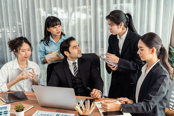 Diverse of business people from various ethnic group working in modern office environment. Productive and multi ethnic office workers engage in discussion for strategic business marketing. Meticulous