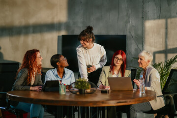 Interracial female team collaborating on a project at conference room.