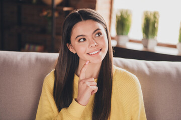Photo portrait of nice teen lady sit couch look minded empty space dressed yellow garment spend...