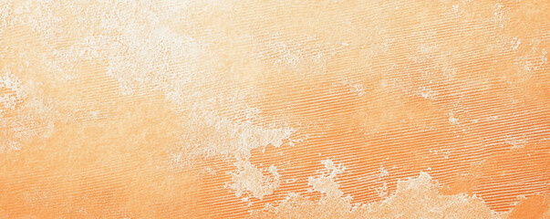 Fototapeta premium A light pastel orange surface with a fine, stippled texture. The warm, cheerful hue and subtle texture add a cozy and inviting feel to the background.