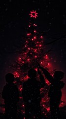 Children decorating a christmas tree with red lights at night
