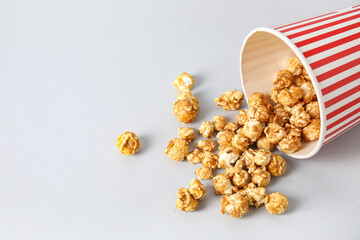 Bucket with tasty popcorn on grey background