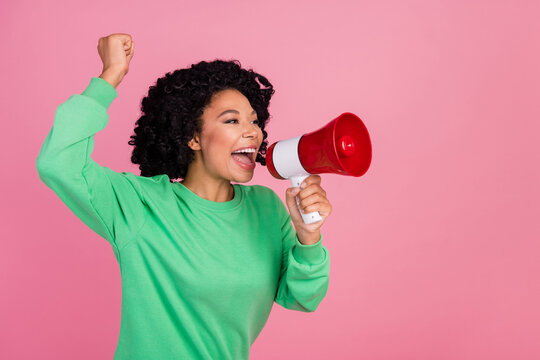 Photo of young woman activist raised fist up screaming supporting president election candidate isolated on pink color background