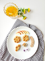 Moon cake cut, apple, ham sausage and drink, white background, top view