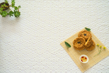 Close-up egg shortbread, goji tea, succulent plant, top view