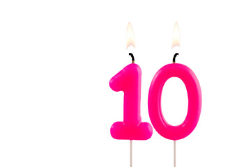 Pink number 10 birthday candle on white background