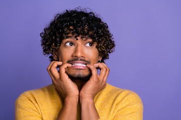 Photo of terrified frightened man wear trendy yellow clothes look empty space isolated on violet color background