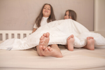 little girls playing in their room and tickling and hugging each other