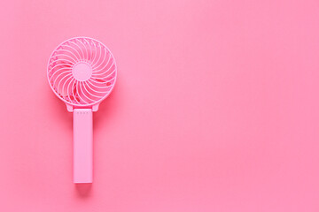 Modern manual fan on pink background