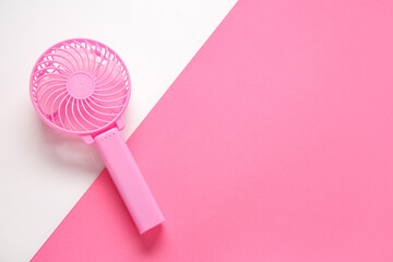 Modern manual fan on color background