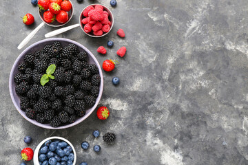 Composition with different fresh berries on grey background