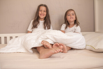little girls playing in their room and tickling and hugging each other