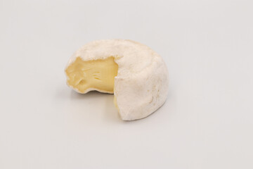 Italian cheese from Valtellina, cow's milk tomino, soft consistency, very light straw-coloured paste, soft white velvety rind, isolated on white background