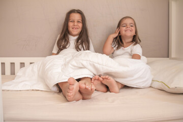 little girls playing in their room and tickling and hugging each other