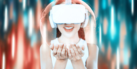 Female stand and wear white VR headset and white sleeveless connect metaverse, future technology,...