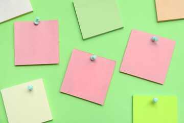 Paper notes pinned on green background