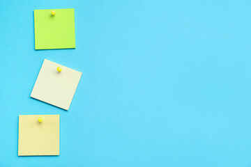 Paper notes pinned on blue background