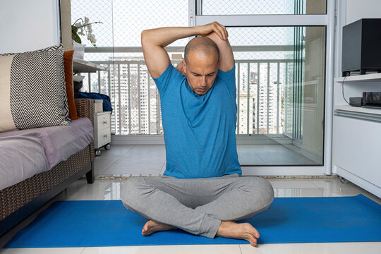 48 year old Brazilian man practicing yoga at his home_4.
