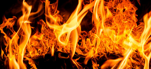 Fire flames on black background. Fire sparks background. Abstract dark fire flames background....