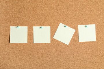 Blank sticky notes on cork board as background