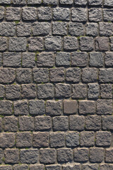 Stone road background texture. Textured background of cobblestone road. Road from brick background. Paving stone and paved road. Sidewalk background.