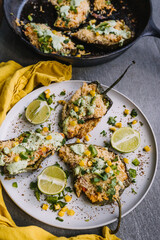 Homemade Chicken and Rice stuffed Pablano peppers on a plate  with cilantro lime cream sauce