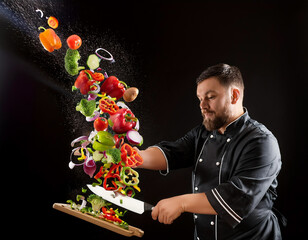 A cascade of vibrant, chopped vegetables pouring out of a chef?s knife as it slices through  (31).jpg