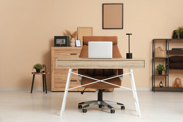 Interior of office with workplace and safe on commode