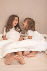 little girls playing in their room and tickling and hugging each other