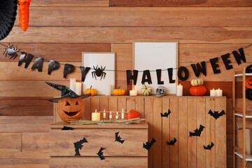 Interior of living room decorated for Halloween with burning candles and commode