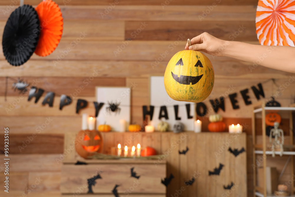 Wall mural Woman with Halloween pumpkin at home, closeup