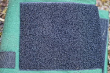 large black square velcro on green fabric of blood pressure monitor tonometer