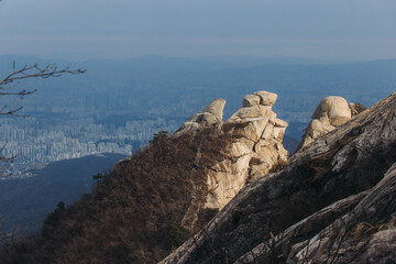 Fototapeta premium Bukhansan National Park, Seoul, Gyeonggi-do, South Korea, spring landscape view during hike to Baegundae summit peak, process of trekking and climbing to Bukhan mountain, travel and hiking in Korea
