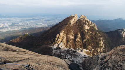 Bukhansan National Park, Seoul, Gyeonggi-do, South Korea, spring landscape view during hike to Baegundae summit peak, process of trekking and climbing to Bukhan mountain, travel and hiking in Korea