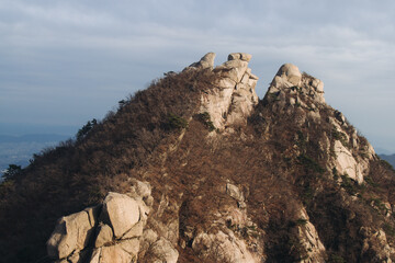 Fototapeta premium Bukhansan National Park, Seoul, Gyeonggi-do, South Korea, spring landscape view during hike to Baegundae summit peak, process of trekking and climbing to Bukhan mountain, travel and hiking in Korea