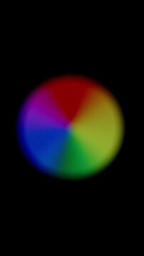 Cyclically Expanding Rainbow Orb, with soft, blurred segments in multiple colors, dynamically increasing and decreasing in size to show ongoing loading.
