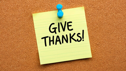 give thanks word written on a note sticky on corkboard