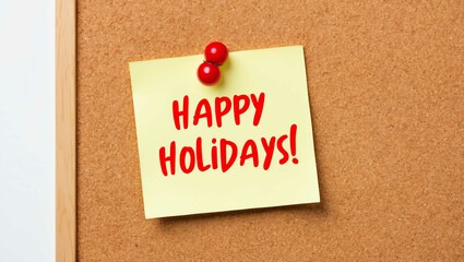 happy holidays word written on a note sticky on corkboard