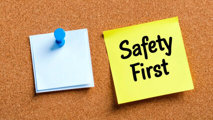 safety first word written on a note sticky on corkboard