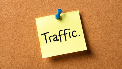 traffic word written on a note sticky on corkboard