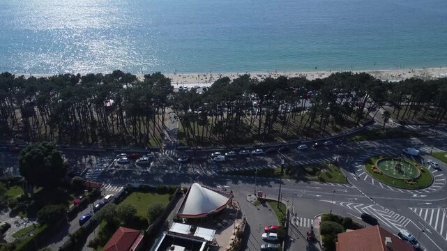 Aerial view of Playa de Samil, the main beach of Vigo in Galicia in northwest Spain. Sunny day, crystal clear blue sea. Houses, streets. Drone take.