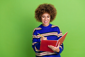 Photo of pretty charming woman wear blue striped trendy clothes hold planner notes empty space isolated on green color background