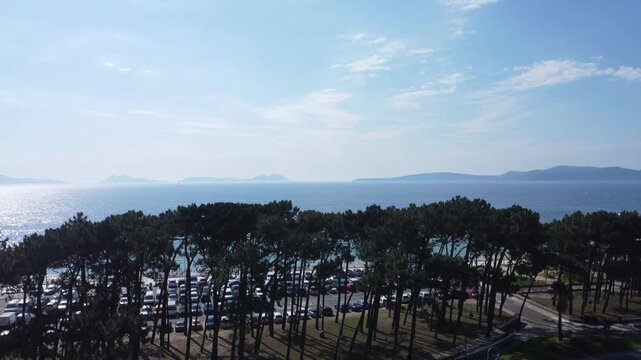 Aerial view of Playa de Samil, the main beach of Vigo in Galicia in northwest Spain. Sunny day, crystal clear blue sea. Houses, streets. Drone take.