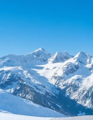 Majestic snow-capped mountain peaks under a clear blue sky in winter