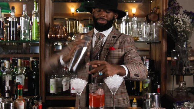 Black bartender preparing a cocktail in a traditional cocktail bar