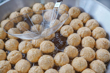 Fried meatballs being fried close up from the frying pan