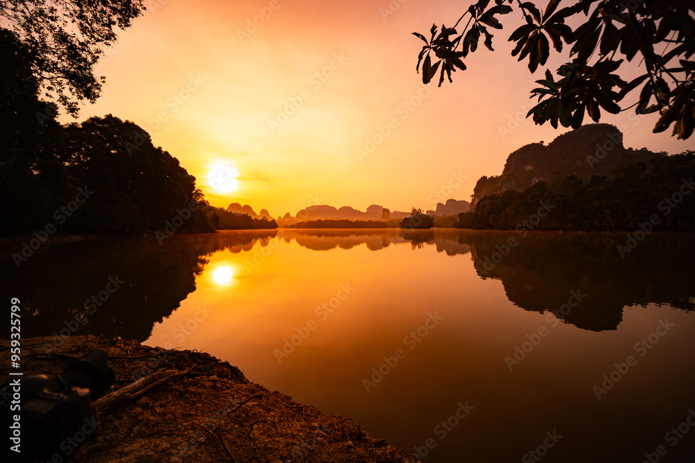 Wall mural beautiful landscape nature view sunrise morning with reflections light over water surface during sun