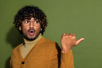 Photo portrait of attractive young man point look shocked empty space dressed stylish brown clothes...