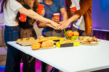 A group of Asian friends gathers in an office for a night of BBQ, pizza, and drinks, celebrating Halloween with vibrant RGB lighting, laughter, and cheering for their favorite soccer team.